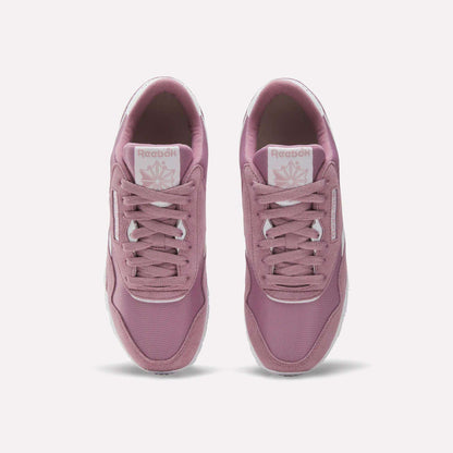 A pair of Women's Classic Nylon Shoes by Reebok in mauve pink retro style, shown from above with visible laces, branded tongue, and white outsoles on a light background.