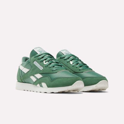 The Women's Classic Nylon Shoes by Reebok, featuring a green nylon and suede upper with white accents and soles, are displayed on a plain light background.