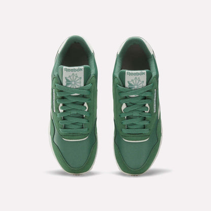 Reebok Women's Classic Nylon Shoes in green feature retro style, white logos on the tongues and sides, white midsoles, and green laces—crafted from nylon and suede for timeless appeal.