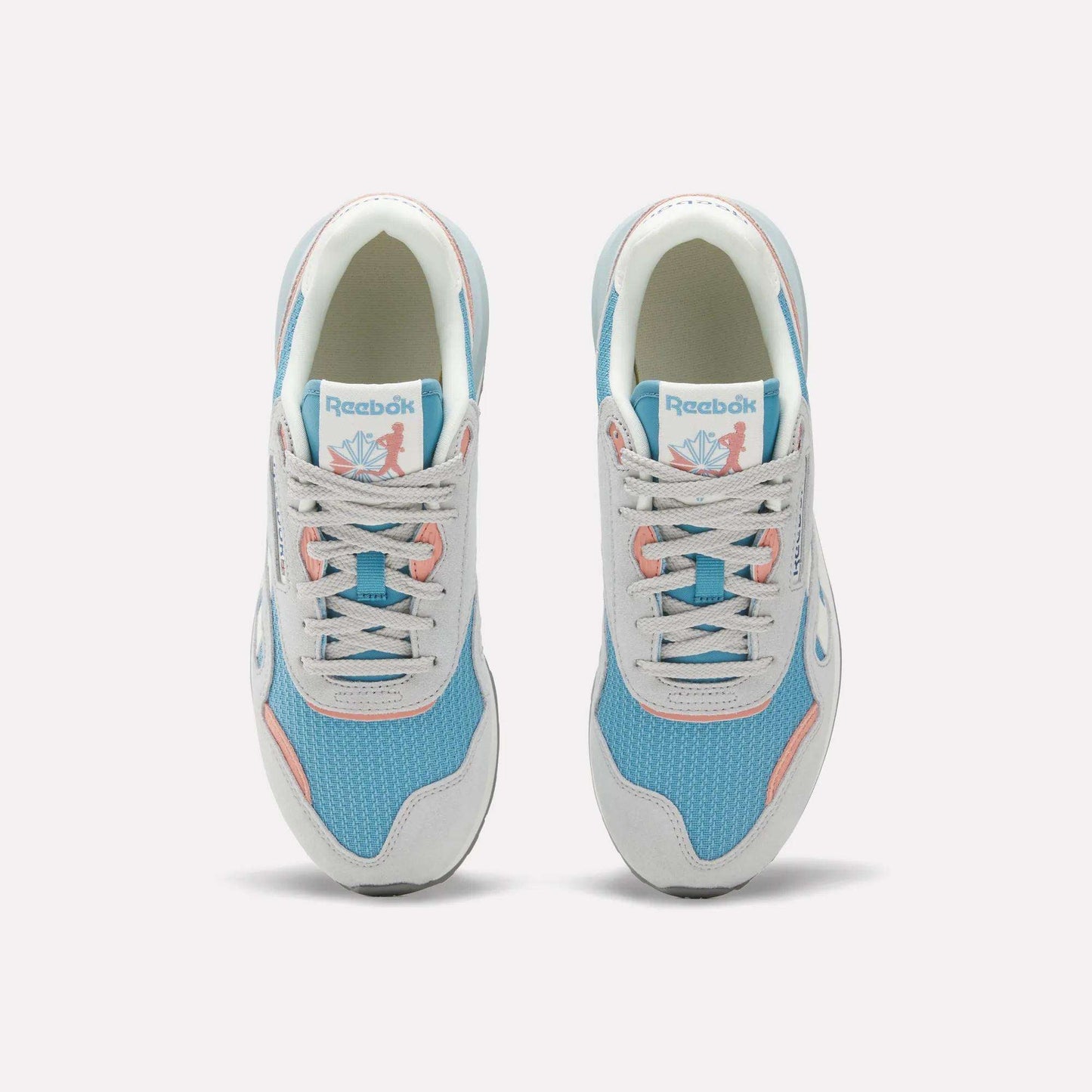 The Reebok Women's Classic Nylon 89 Shoes, seen from above, feature light blue mesh, white overlays, light gray laces, pink accents, retro style details, and the Reebok logo on the tongue.