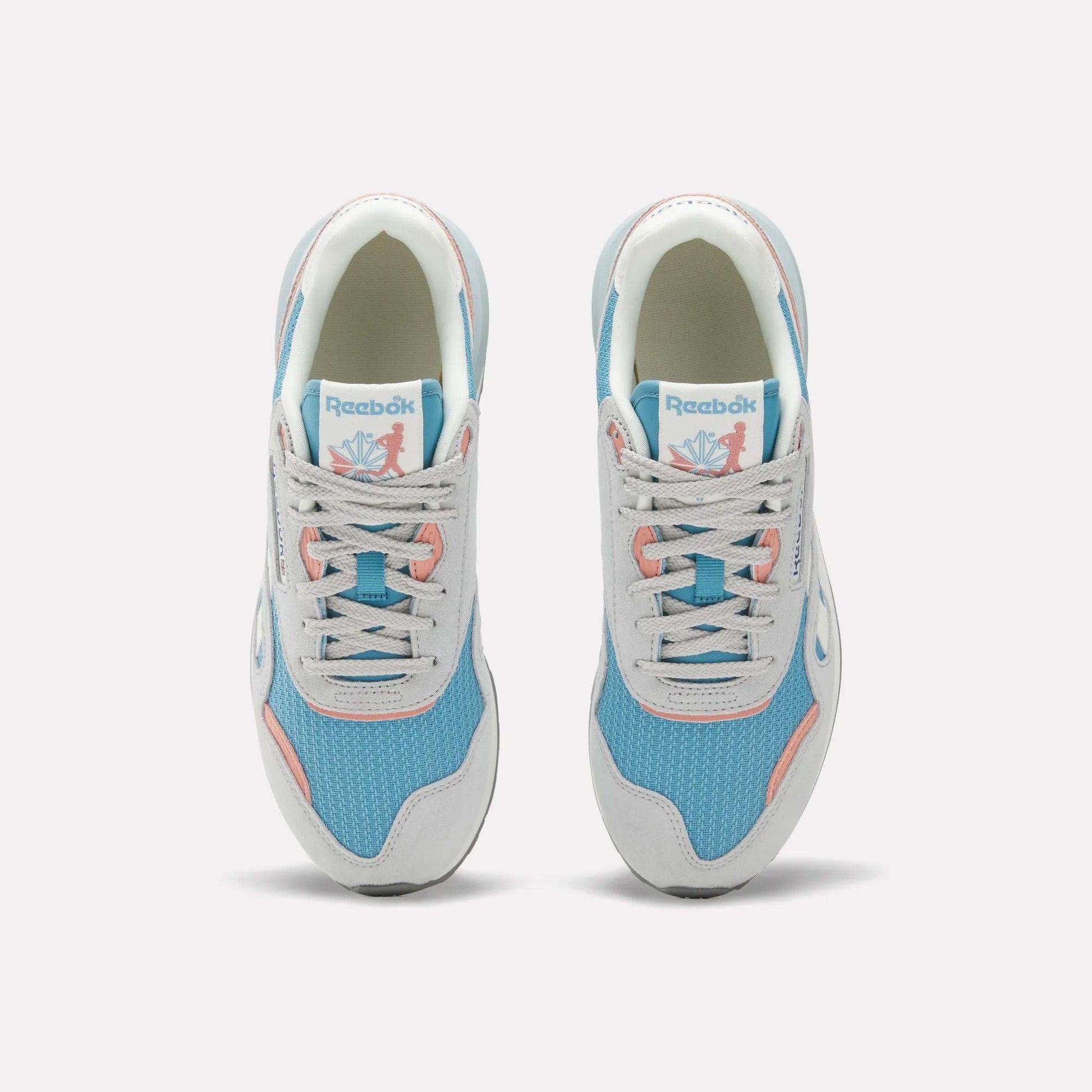 The Reebok Women's Classic Nylon 89 Shoes, seen from above, feature light blue mesh, white overlays, light gray laces, pink accents, retro style details, and the Reebok logo on the tongue.