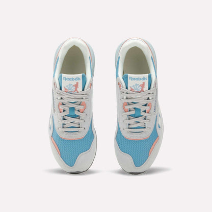 The Reebok Women's Classic Nylon 89 Shoes, seen from above, feature light blue mesh, white overlays, light gray laces, pink accents, retro style details, and the Reebok logo on the tongue.