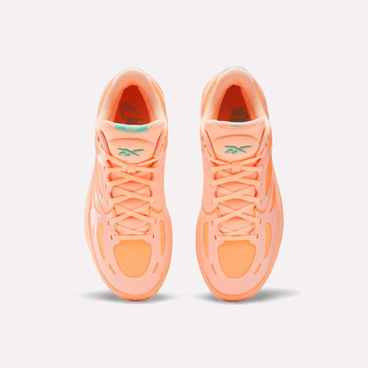 Top view of bright orange Reebok Engine A Basketball Shoes with ERS technology for energy return and light teal tongue logos, set against a plain white background.