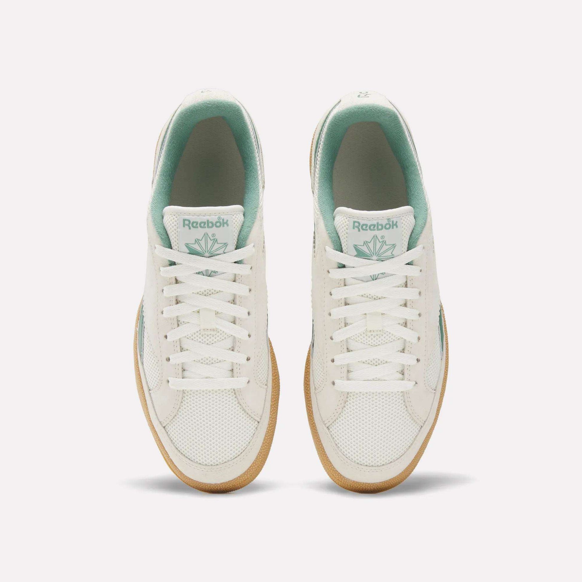 Top view of Reebok Club C Grounds 70 Shoes in white with mint green accents, white laces, and gum soles. Inspired by the '70s, these sneakers feature premium suede details and are displayed side by side on a plain white background.