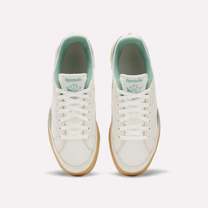 Top view of Reebok Club C Grounds 70 Shoes in white with mint green accents, white laces, and gum soles. Inspired by the '70s, these sneakers feature premium suede details and are displayed side by side on a plain white background.