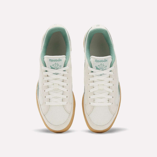 Top view of Reebok Club C Grounds 70 Shoes in white with mint green accents, white laces, and gum soles. Inspired by the '70s, these sneakers feature premium suede details and are displayed side by side on a plain white background.