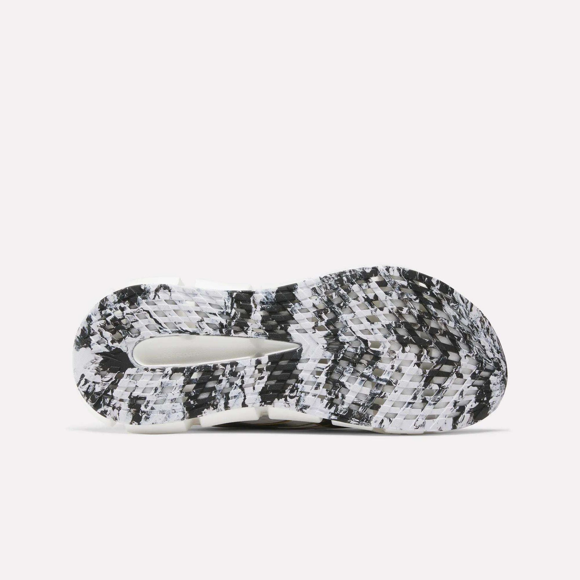 The image displays the sole of Reebok FloatZig 2 Running Shoes, featuring a black, white, and grey marbled pattern with textured treads, a central cutout for enhanced grip, and Superfloat+ cushioning.