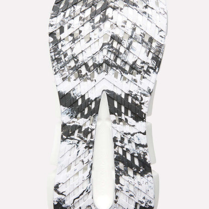 Close-up of the Reebok FloatZig 2 Running Shoes sole featuring a black, white, and gray marbled pattern, textured angular grooves for traction, and Superfloat+ cushioning for responsive comfort.
