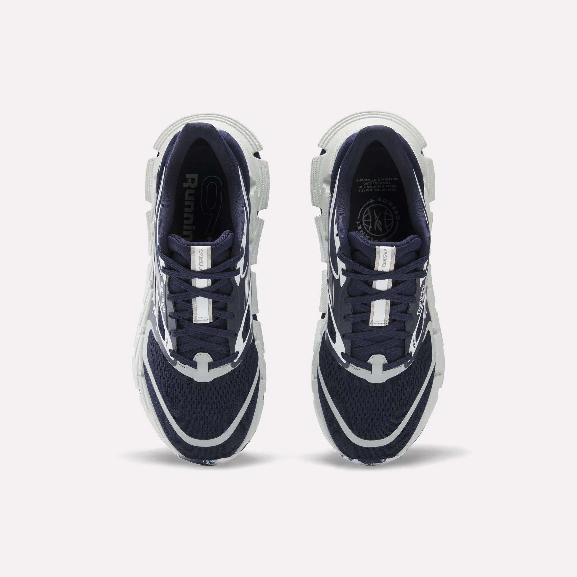 A pair of Reebok FloatZig 2 Running Shoes in navy blue and white are shown from above on a white background. They feature mesh uppers, Superfloat+ cushioning, white accents, and chunky white soles.