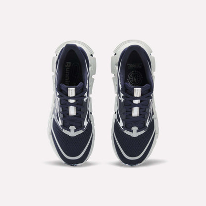 A pair of Reebok FloatZig 2 Running Shoes in navy blue and white are shown from above on a white background. They feature mesh uppers, Superfloat+ cushioning, white accents, and chunky white soles.