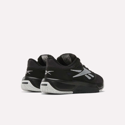 A pair of Reebok Engine LT Shoes in black and white with silver accents, shown from the back and side on a plain light background.