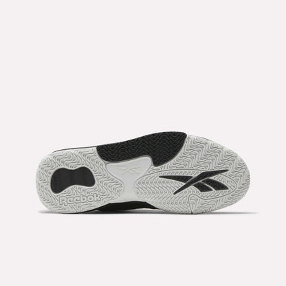 The image shows the sole of Reebok Engine LT Shoes, featuring a textured white, black, and grey rubber outsole with various tread patterns and the Reebok logo clearly visible.