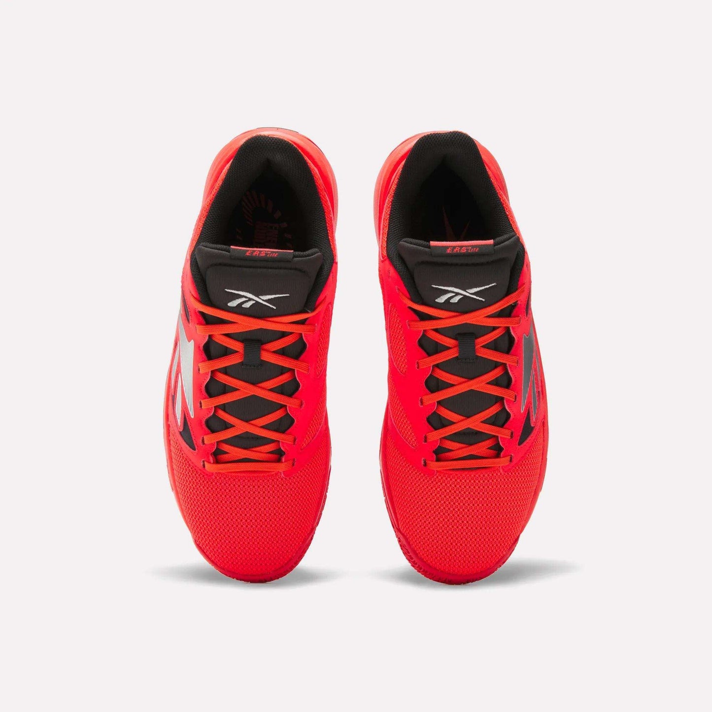 Top view of a pair of Reebok Engine LT Shoes in bright red with black interiors, black and red tongues, and black side detailing, displayed on a plain white background.
