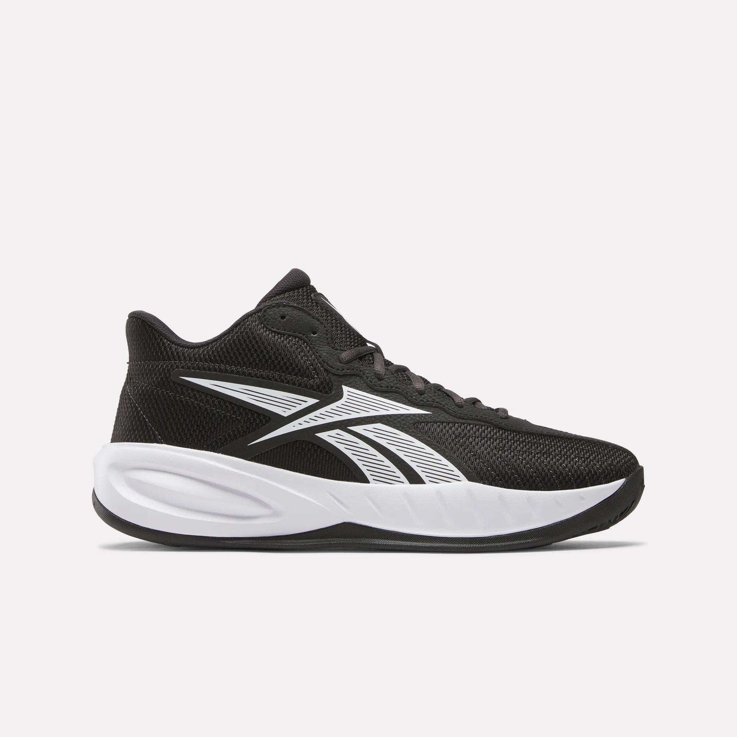 The Reebok Press Basketball Shoes are black sneakers with white accents, a thick white sole, and the Reebok logo on the side. Lightweight mesh upper and EVA cushioning deliver responsive all-day comfort for court or casual wear.