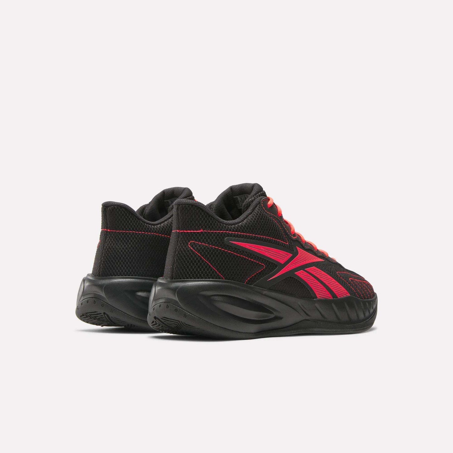 A pair of Reebok Press Retro Basketball Shoes in black with bold red accents and laces, featuring EVA cushioning for comfort, shown from back and side angles on a white background.