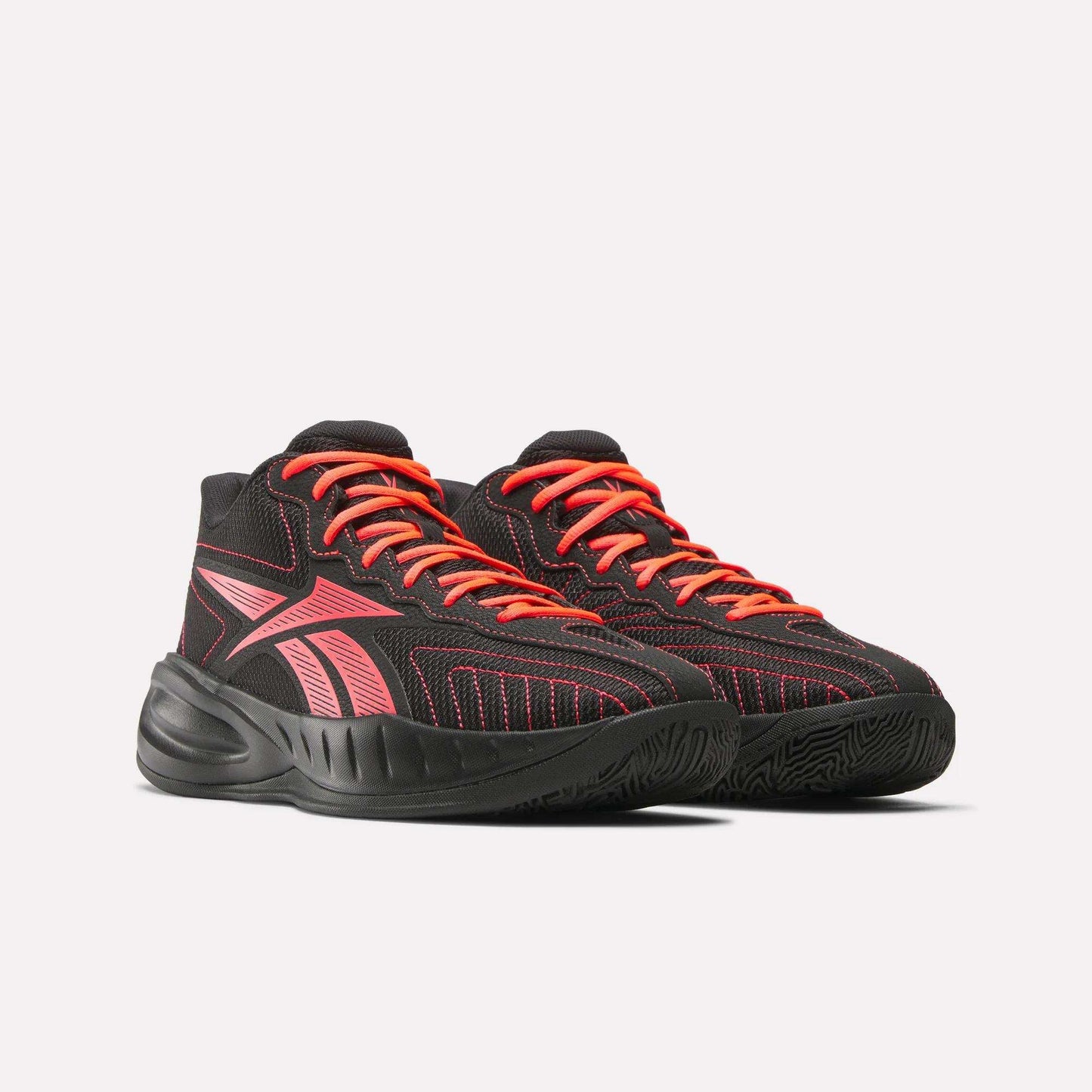 The Reebok Press Retro Basketball Shoes feature black uppers with bright red accents and red laces, a dynamic striped design, and chunky EVA-cushioned soles. They are displayed side by side on a light background.