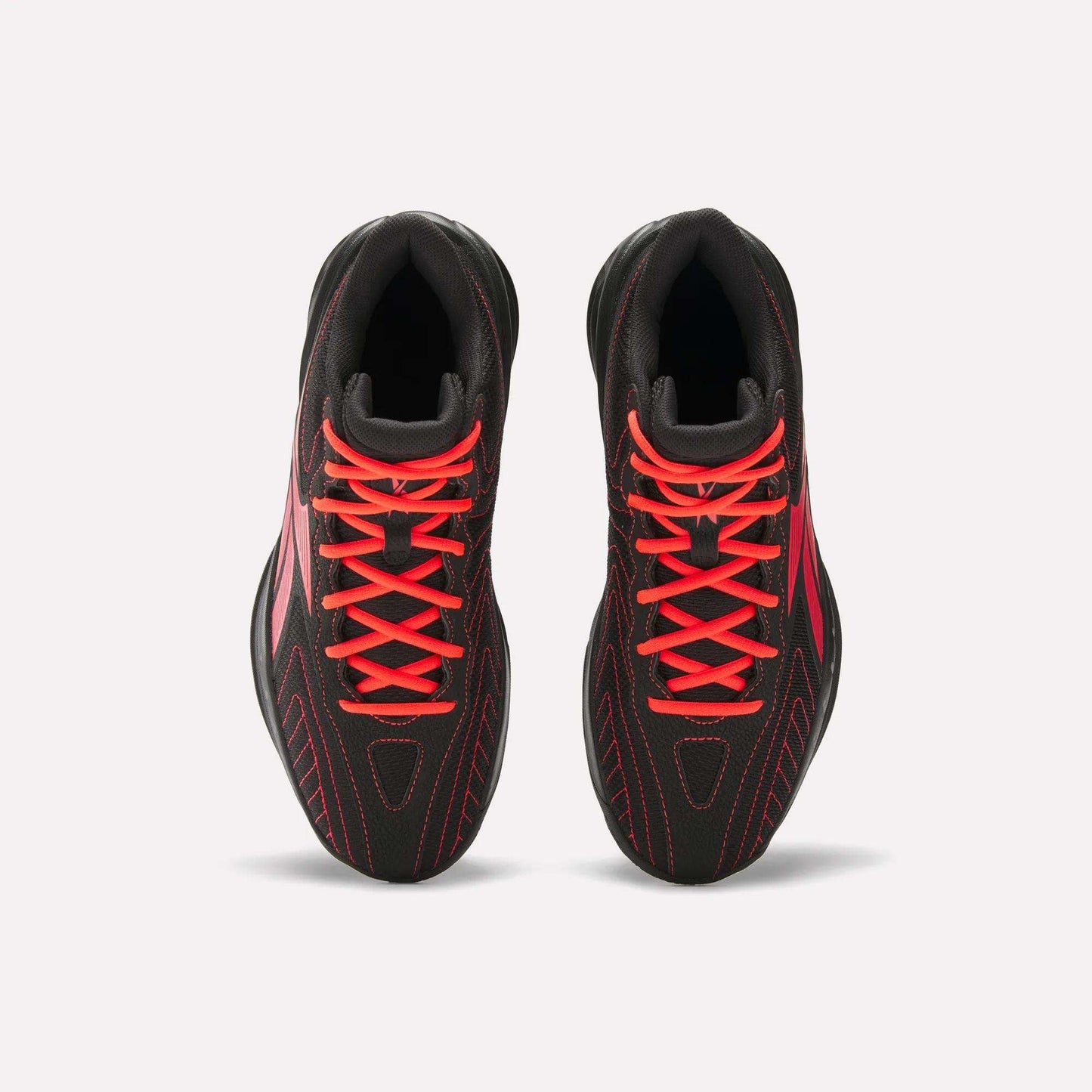 Top view of a pair of Reebok Press Retro Basketball Shoes in black with bright red laces, red stitching, and EVA cushioning, displayed side by side on a plain white background.