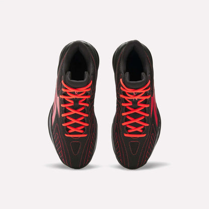 Top view of a pair of Reebok Press Retro Basketball Shoes in black with bright red laces, red stitching, and EVA cushioning, displayed side by side on a plain white background.