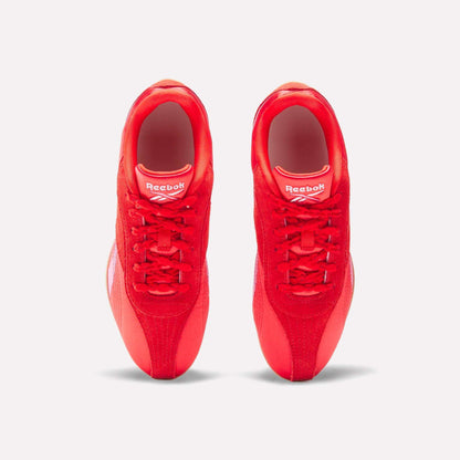 Top view of Reebok Women's Ultra Lo Shoes in bright red with white logo accents on the tongues, placed side by side on a plain white background, highlighting their sporty design.