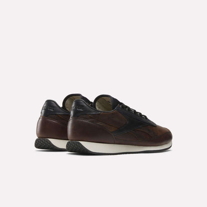 The Reebok Camargue x C.F. Stead Shoes are brown and black full-grain leather sneakers with white soles, shown from the back and side against a plain light background.