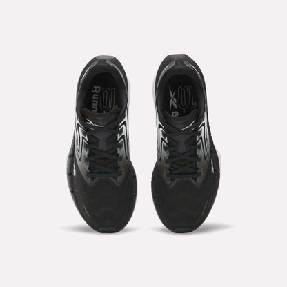 Top view of Reebok Women's FloatZig Tread Running Shoes with white accents on a white background. Features breathable mesh uppers and branded insoles, ideal for treadmill workouts.