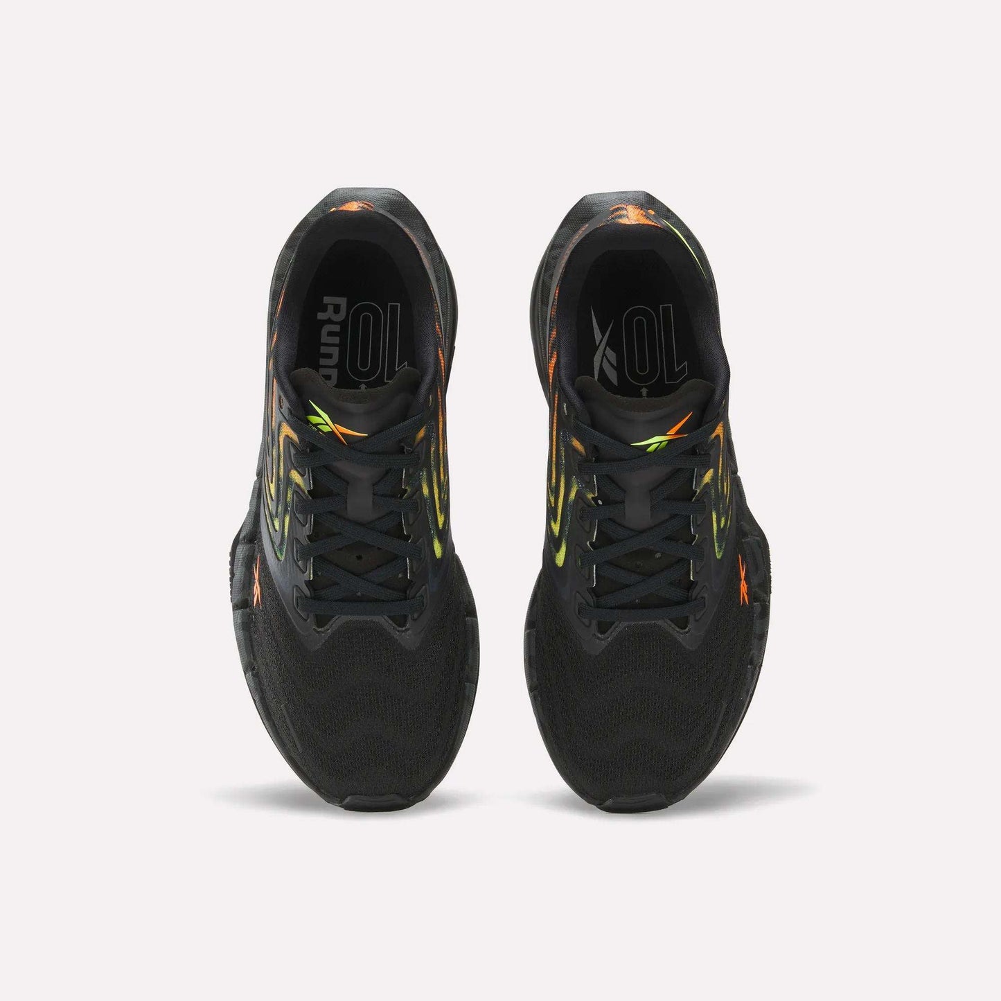 The Reebok Women's FloatZig Tread Running Shoes feature a black breathable mesh upper with neon yellow and orange accents. Seen from above on a white background, the insoles read "Run" and "10L," making them ideal for treadmill workouts.