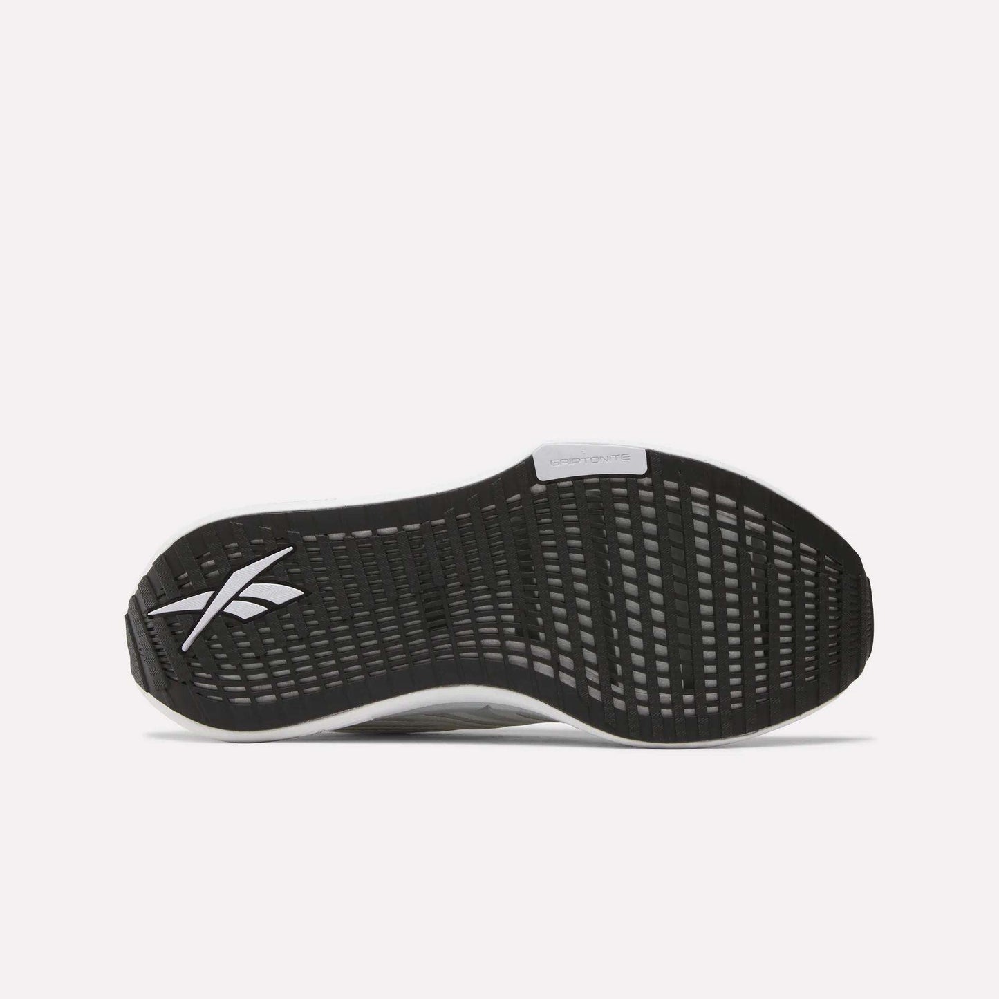 The image shows the black rubber outsole of Reebok Women's FloatZig Tread Running Shoes, featuring a grid-like tread pattern and a white Reebok logo near the heel.