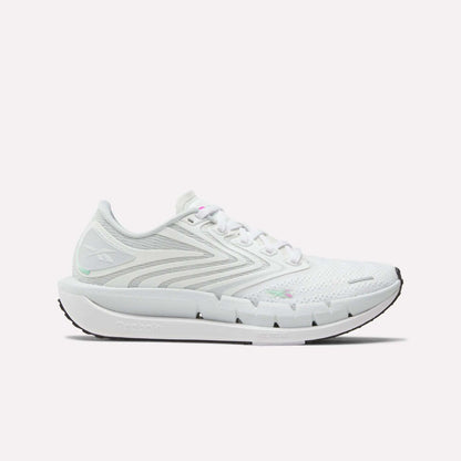 The Reebok Women's FloatZig Tread Running Shoes feature gray accents, a breathable mesh upper, lace-up closure, sculpted sole, and logo on the side and heel. Shown in side view, they're ideal as stylish treadmill running shoes.