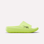 The Reebok DMX Recovery Walking Slides feature a bright yellow-green color, ribbed texture, open toe, black side logo, and moving air cushioning for comfort, shown against a plain white background.