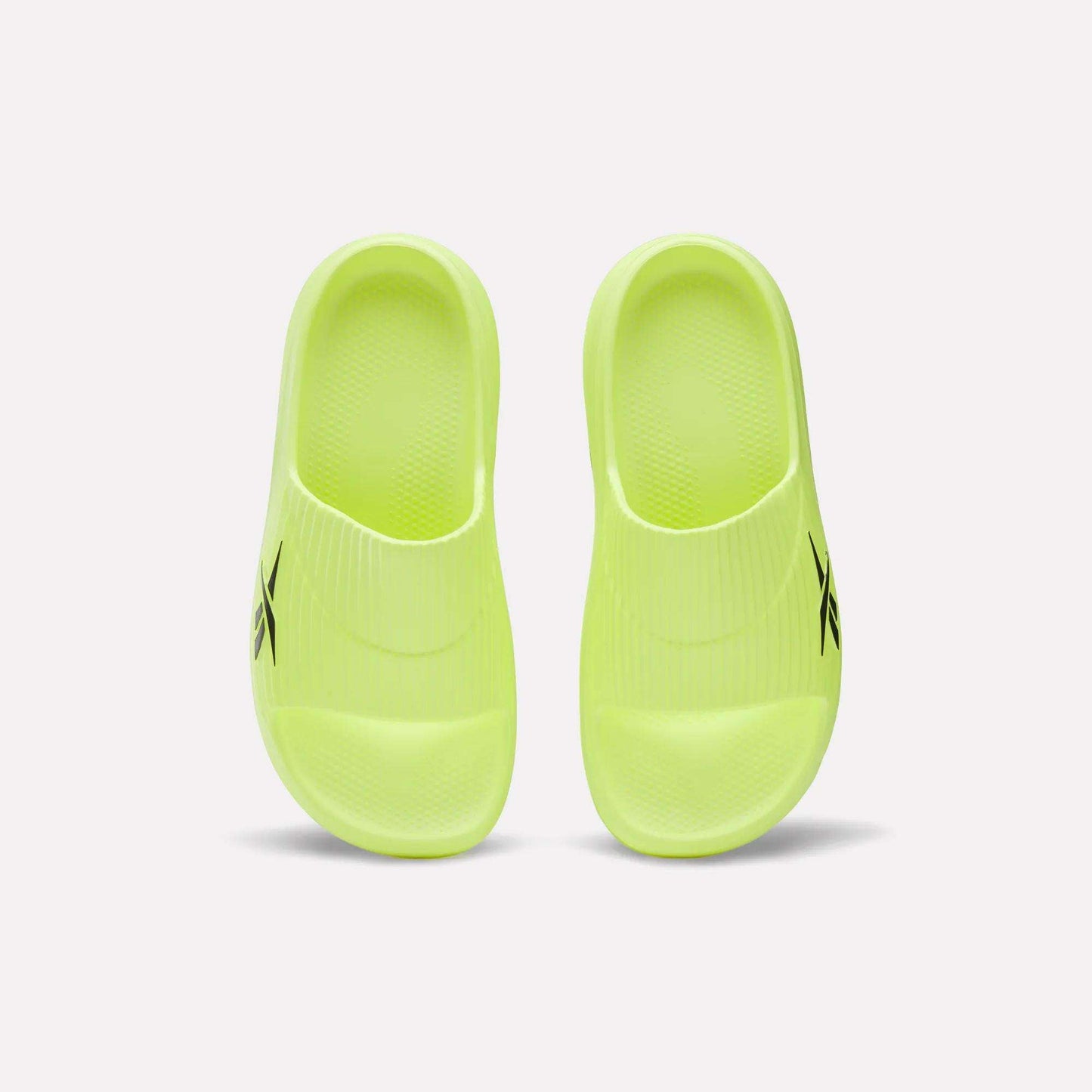 A pair of neon yellow Reebok DMX Recovery Walking Slides with textured footbeds, moving air cushioning, and a black logo on the side, shown from above on a white background.