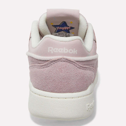 A pink suede Reebok Workout Plus Shoe for little kids, shown from the back with “Reebok” stitched in white on the heel and a star-shaped “Happy!” graphic on the inner tongue—sporty and perfect for any fun outing.