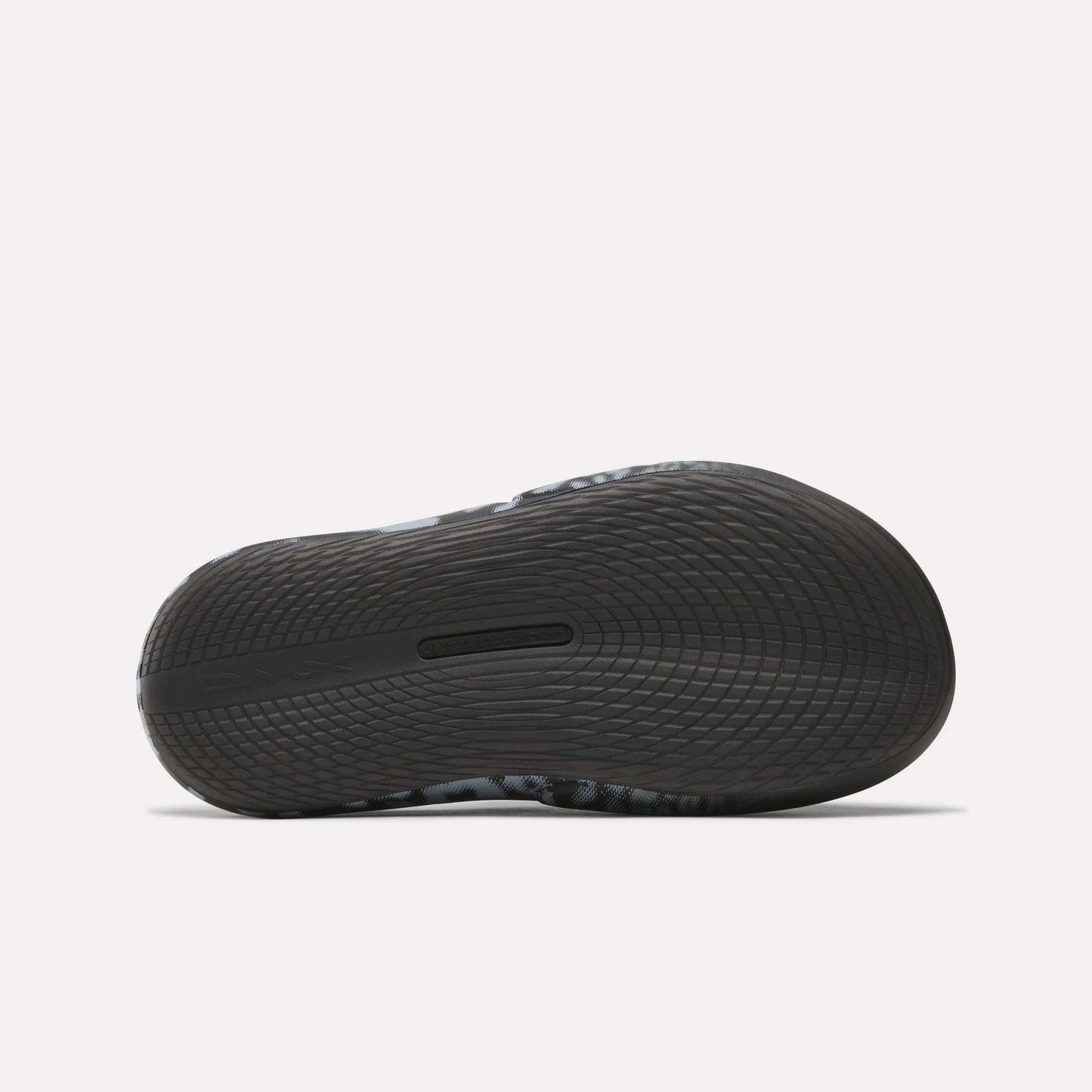 Close-up of the sole on Reebok DMX Recovery Mules, a black athletic shoe with DMX cushioning and wavy tread for excellent grip—perfect as recovery footwear after intense workouts.