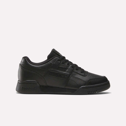 The Reebok Workout Plus Shoes - Big Kids feature a black low-top design with lace-up closure and classic Reebok branding, bringing retro style to juniors’ footwear, shown against a plain white background.