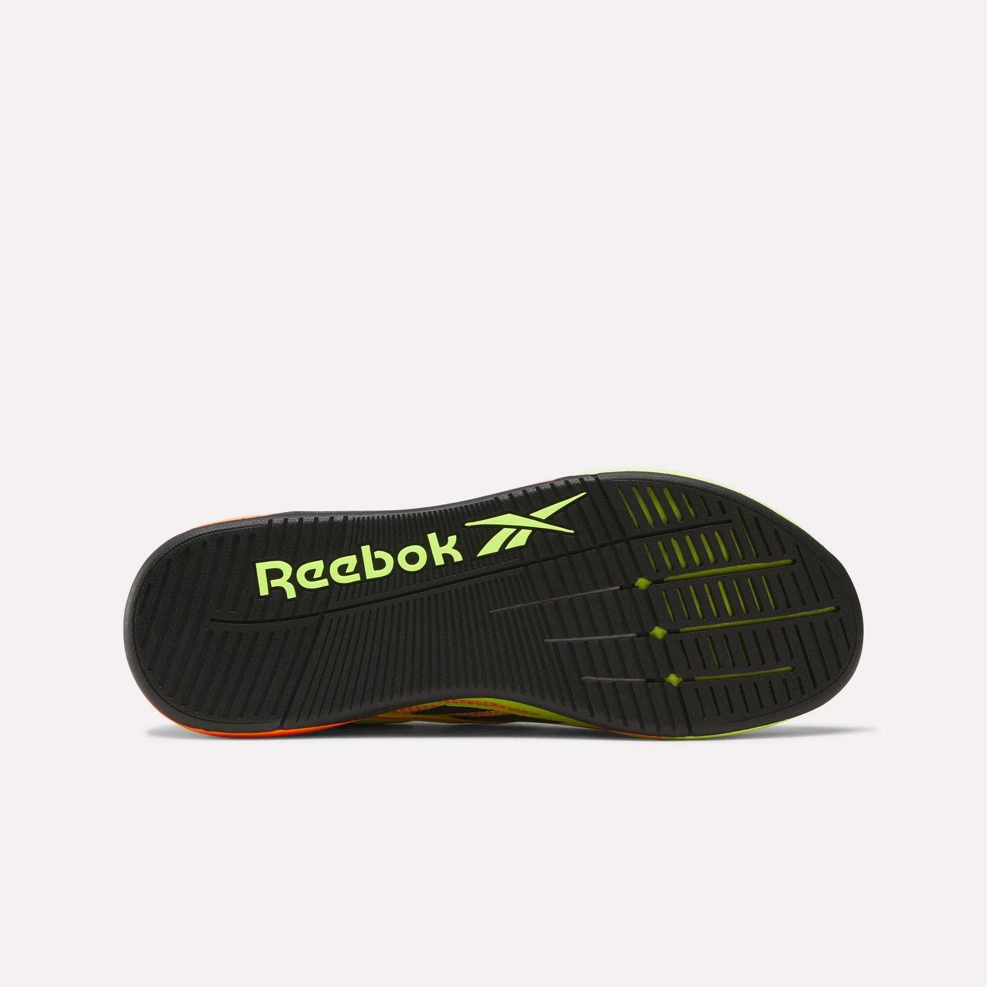 The image displays the sole of Reebok Nano X5 Edge Training Shoes featuring a black base with yellow-green accents, a bold yellow-green Reebok logo, and a durable tread pattern with Flexweave for enhanced grip.