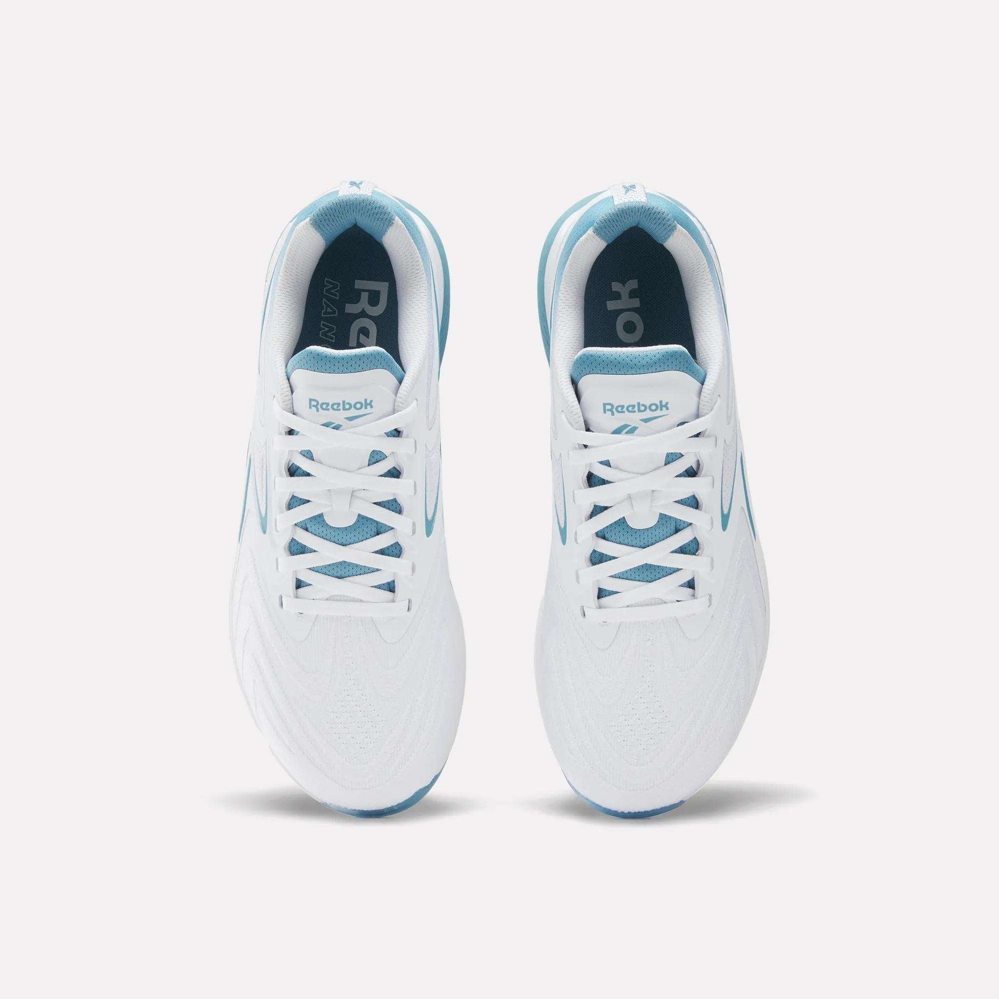 Top view of Reebok Nano X5 Edge Training Shoes in white with blue accents, white laces, and Flexweave mesh at the toe, shown side by side on a plain white background.