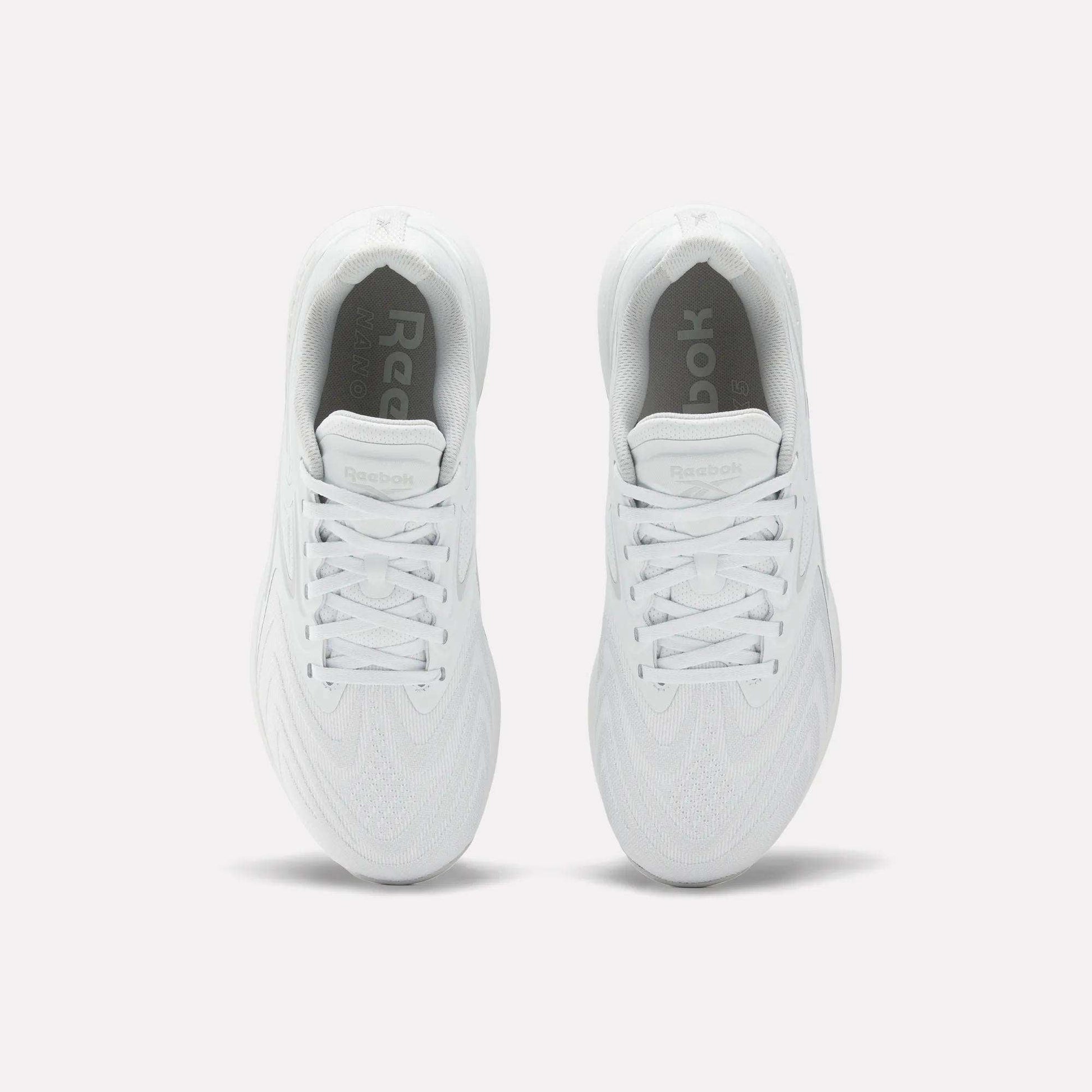 A pair of Reebok Nano X5 Edge Training Shoes in white, shown from above with visible tops, laces, and rounded toe design on a plain white background—ideal for precision training and any workout.