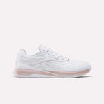 The Reebok Women's Nano X5 Edge Training Shoes feature a white color with pink accents on the sole and heel, a woven texture side design, and the Reebok logo—ideal for versatile workouts.