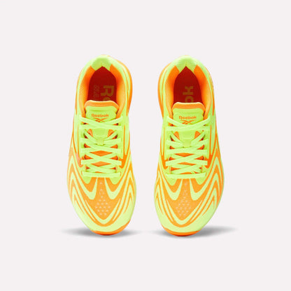 Top view of Reebok Women's Nano X5 Edge Training Shoes in neon yellow and orange with wave patterns and matching laces, ideal for HIIT workouts, shown on a plain white background.