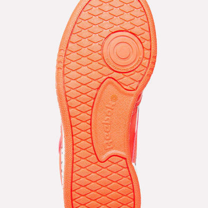 The bright orange sole of the Reebok x Paw Patrol Club C Revenge Shoes for little kids features a textured grip pattern, a circular heel design, retro tennis style vibes, and an embossed Reebok logo at the center.