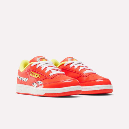 The Reebok x Paw Patrol Club C Revenge Shoes for little kids feature a bold red design, white soles and laces, yellow lining, and Paw Patrol cartoon accents for retro tennis style and all-day comfort.