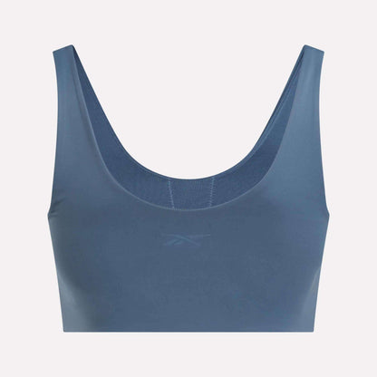 The Reebok Women's Yoga V-Neck Bra features a scoop neckline, wide straps, and a subtle front logo. Its seamless design provides medium-impact support—ideal for studio workouts or casual wear.
