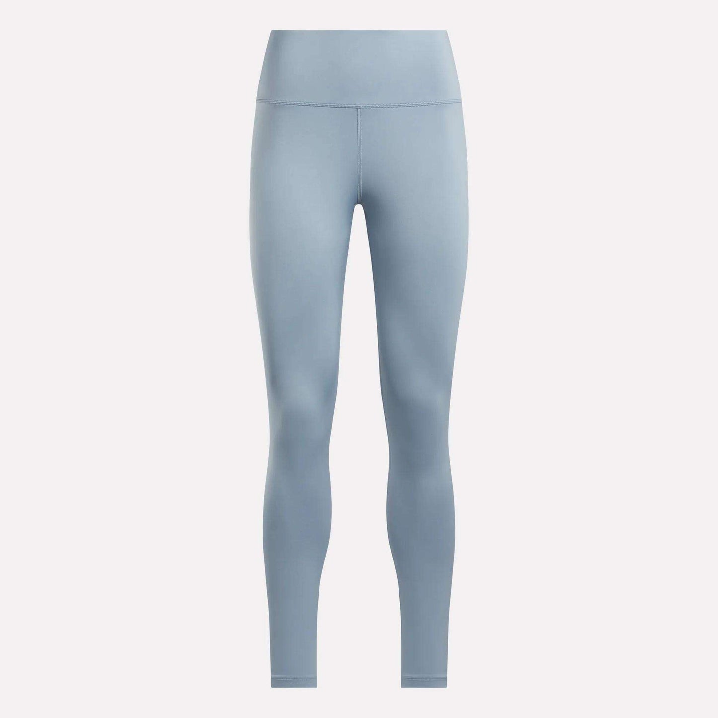 The Reebok Women's Core High-Rise Leggings in light blue feature a seamless, high-waisted, full-length design and are made with RBK-DRY fabric. Shown on a plain white background for a sleek look with no visible patterns or logos.