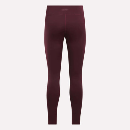 Women's Lux High-Rise Tights by Reebok shown from the back against a light background, with a subtle waistband logo and seamless RBK-DRY fabric for performance.