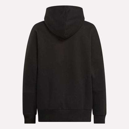 The Reebok Women's Lux Hoodie is shown from the back in plain black, with an oversized fit, long sleeves, and the hood up. It has no visible logos or patterns—ideal for a relaxed, cozy look.
