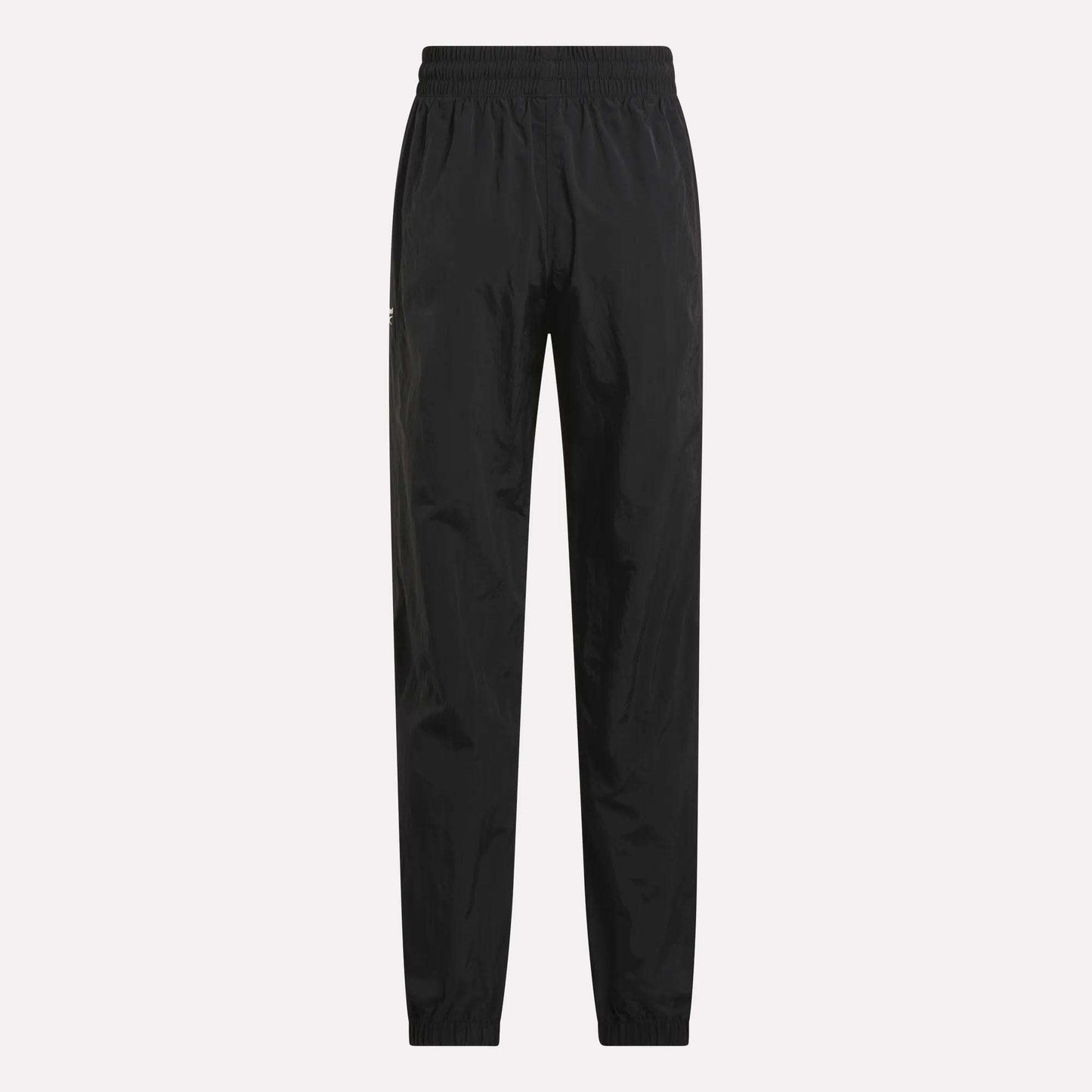 Women's Vector Track Pants by Reebok, shown in black on a plain light background. These feature an elastic waistband and cuffs, straight-leg fit, and lightweight shiny material for a retro-inspired look.
