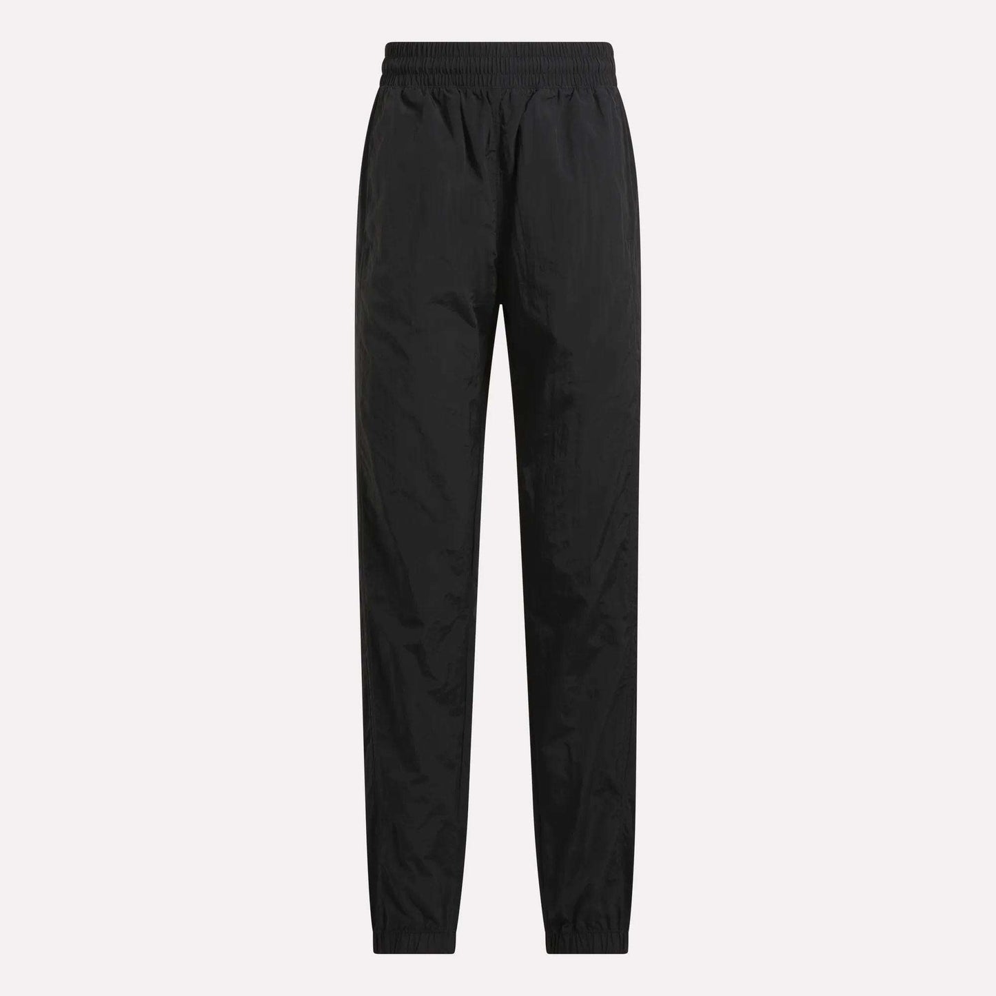 Women's Vector Track Pants by Reebok in black, featuring full length, an elastic waistband, and elastic cuffs, shown against a plain light background.