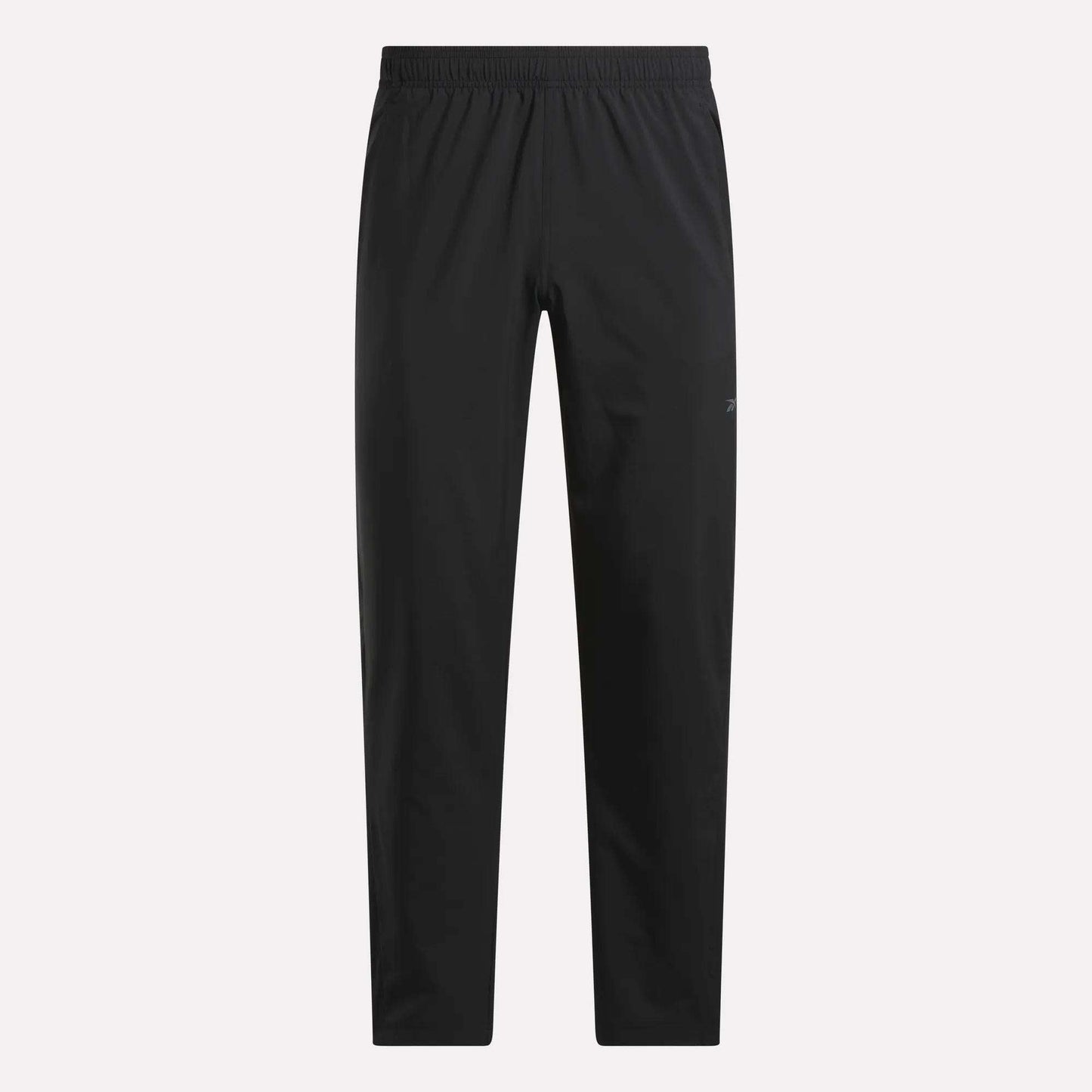 The Reebok Men's Train Woven Unlined Pants feature a black design with an elastic waistband and straight legs. Lightweight and pocketless, they're ideal for gym or daily wear, shown here on a plain white background.