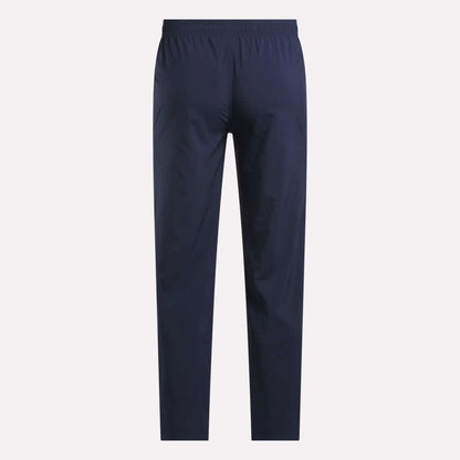 Reebok Men's Train Woven Unlined Pants in navy blue with an elastic waistband, shown from the back against a light background—ideal as lightweight workout or stylish gym pants.