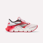 The Reebok Women's FloatZig 2 AHA Running Shoes feature a white, pink, and red mesh upper, black and silver side logo, gradient red-to-white energy-returning midsole, and pink laces, displayed in side profile on a white background.