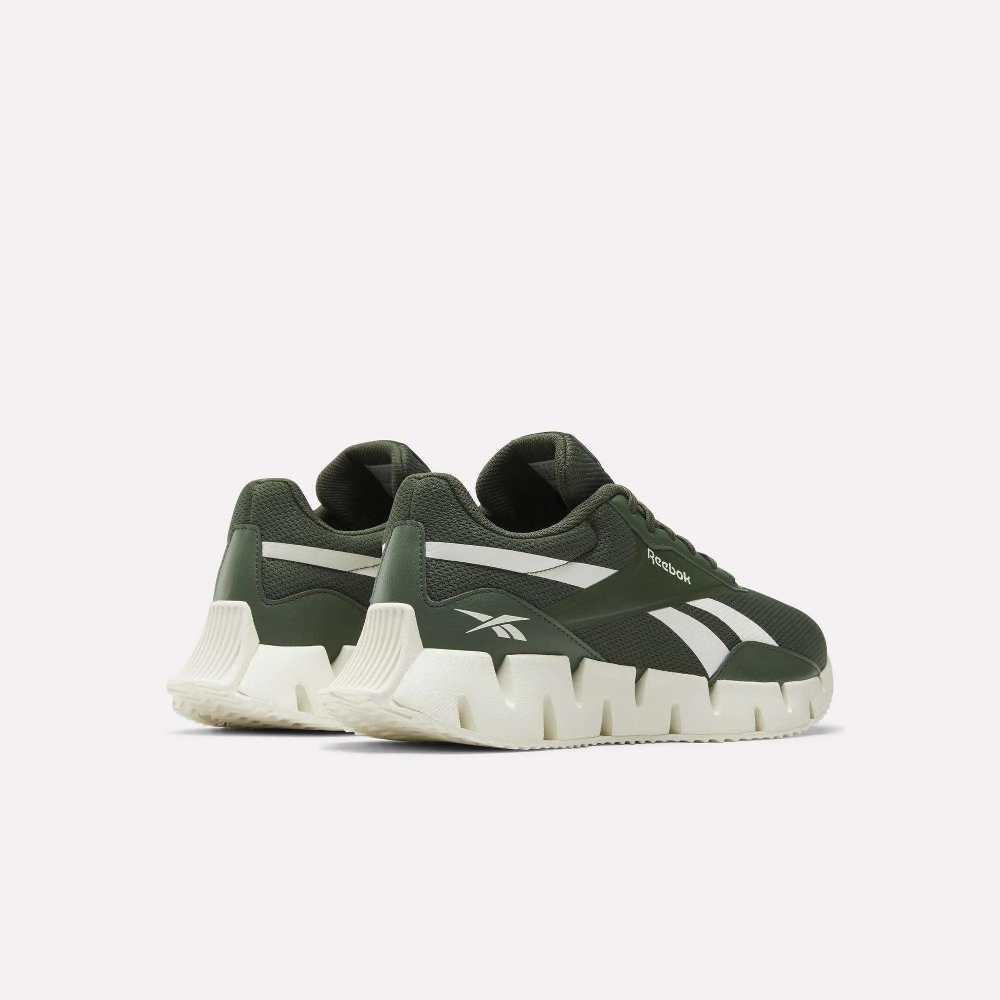 A pair of Reebok Zig Dynamica STR Shoes in green feature breathable mesh, white chunky soles, and white accents, shown from the back and side on a plain white background.